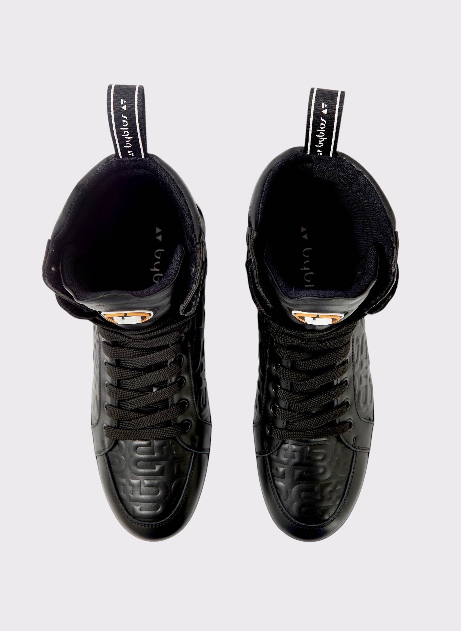 Black high-top sneakers on a light gray background