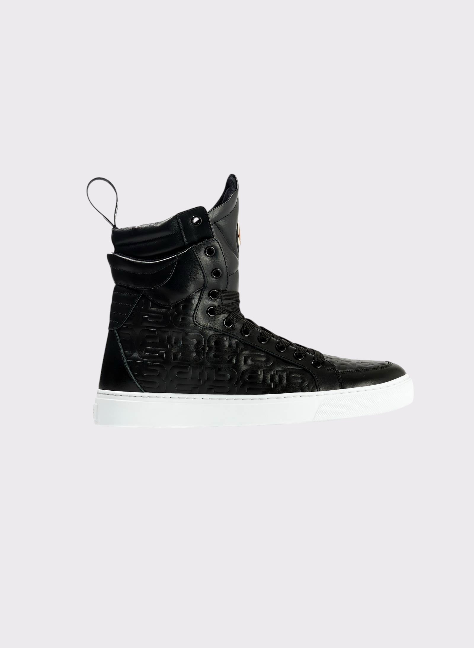 Black high-top sneaker with white sole on a light gray background
