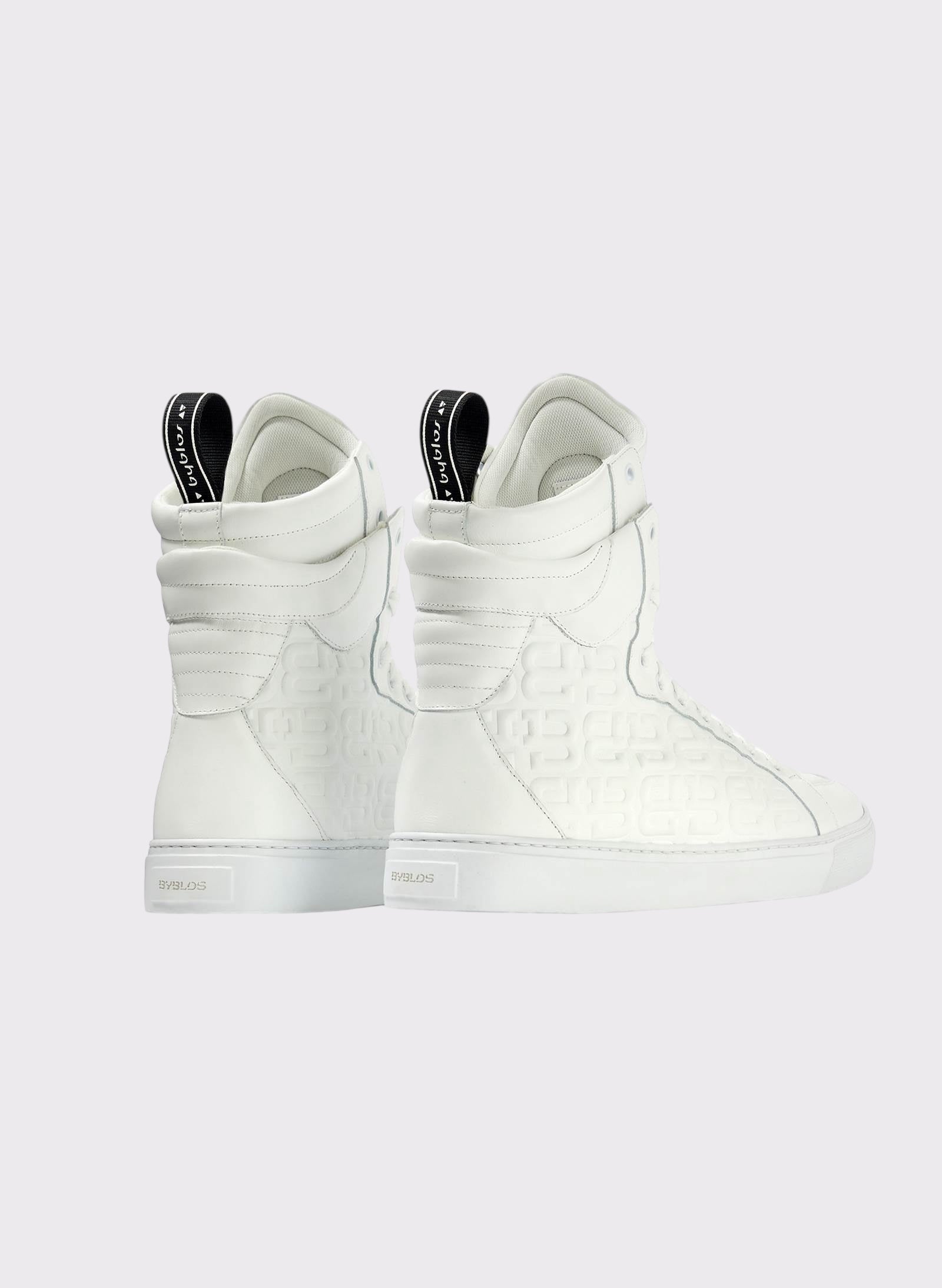White high-top sneakers on a light gray background