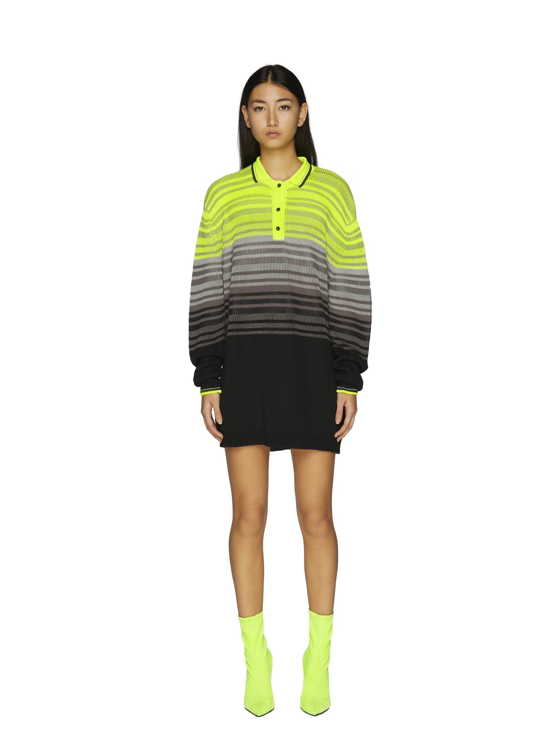 Knit dress in vibrant neon yellow and black with a polo collar and bold striped pattern, paired with matching ankle boots.